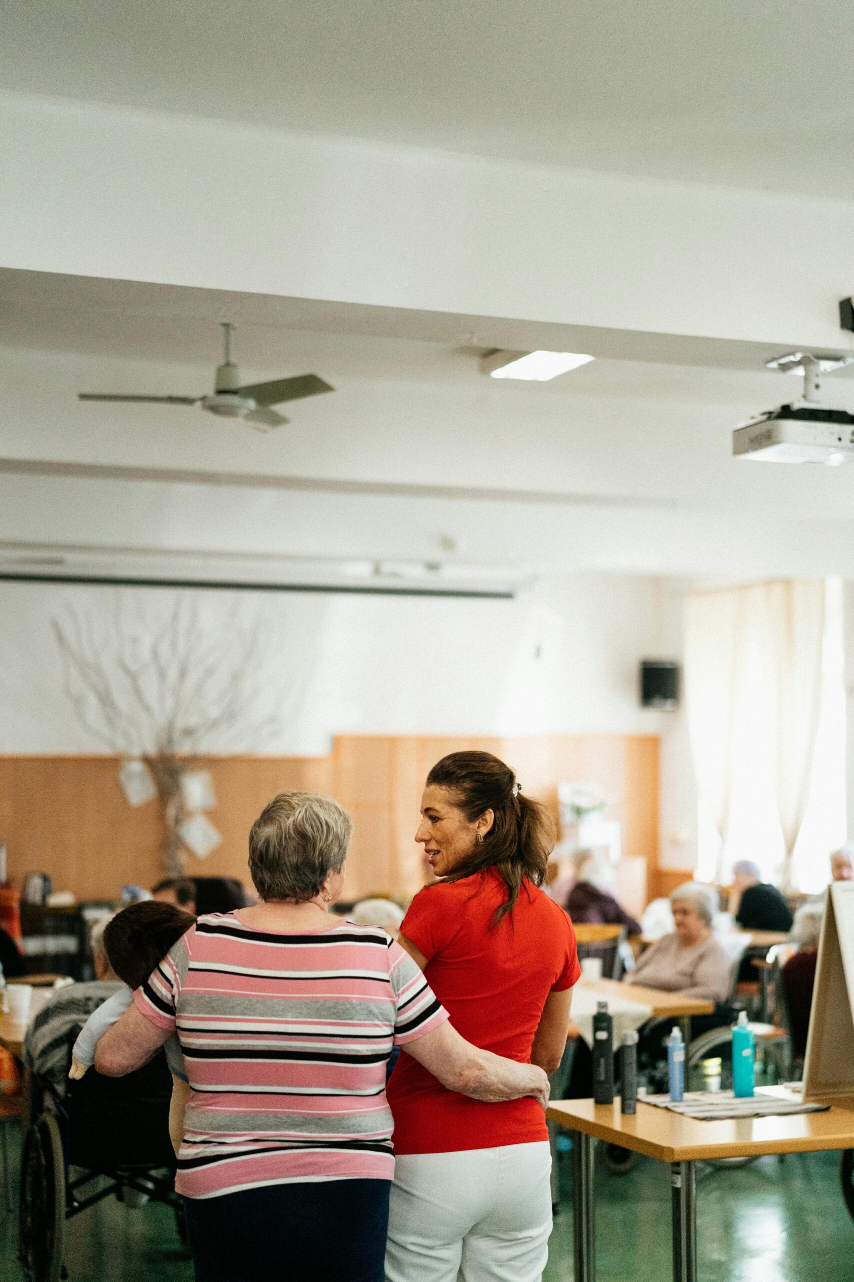 Two women in the common area of a nursing home