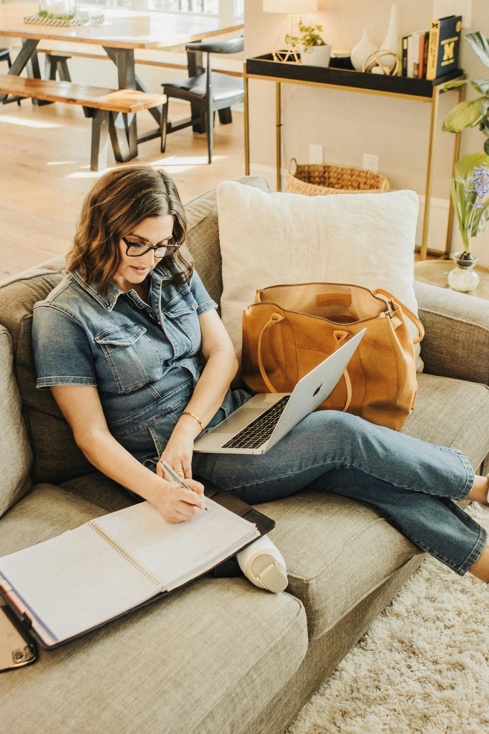 Woman on her laptop while making notes