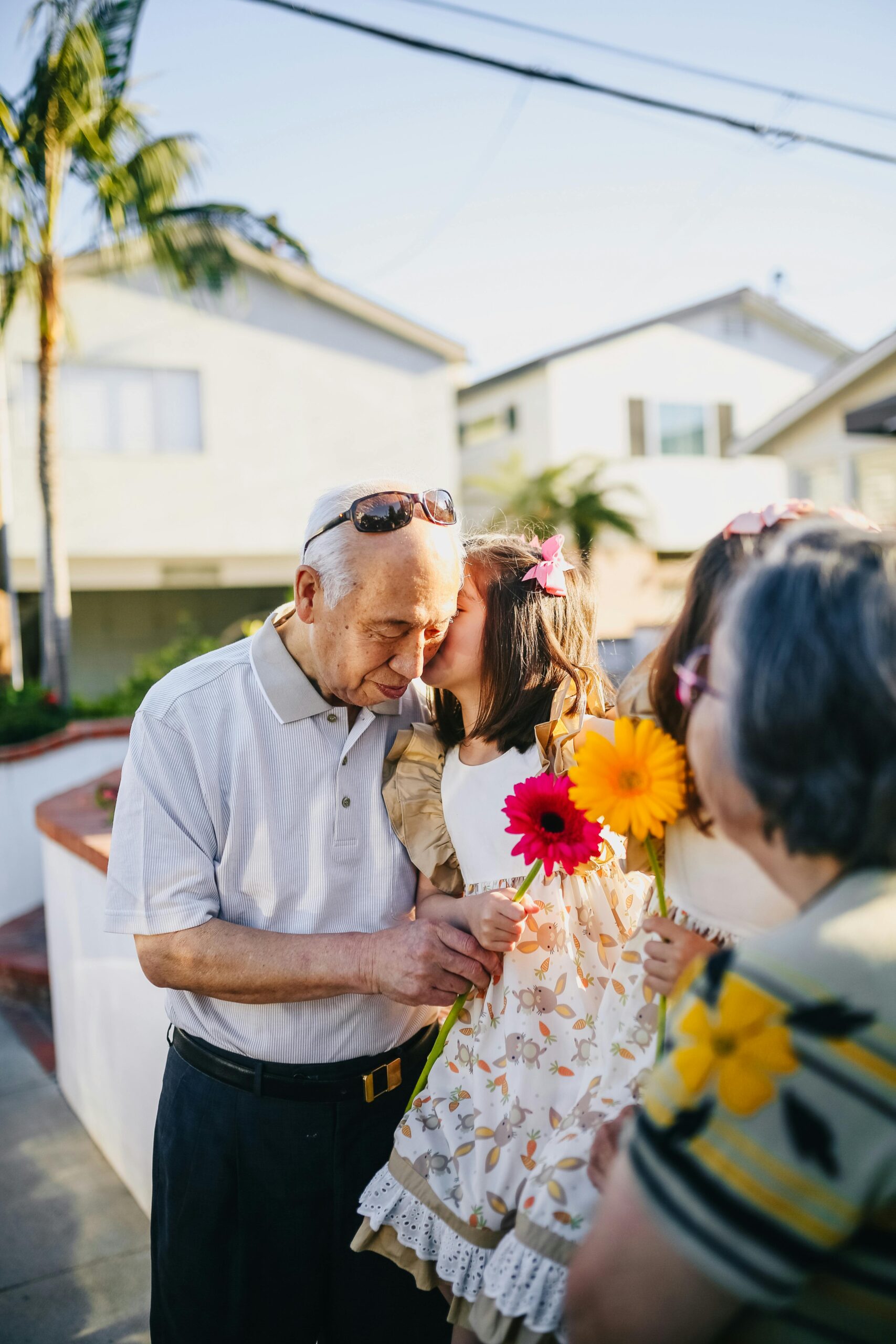 grandchild giving grandfather a kiss