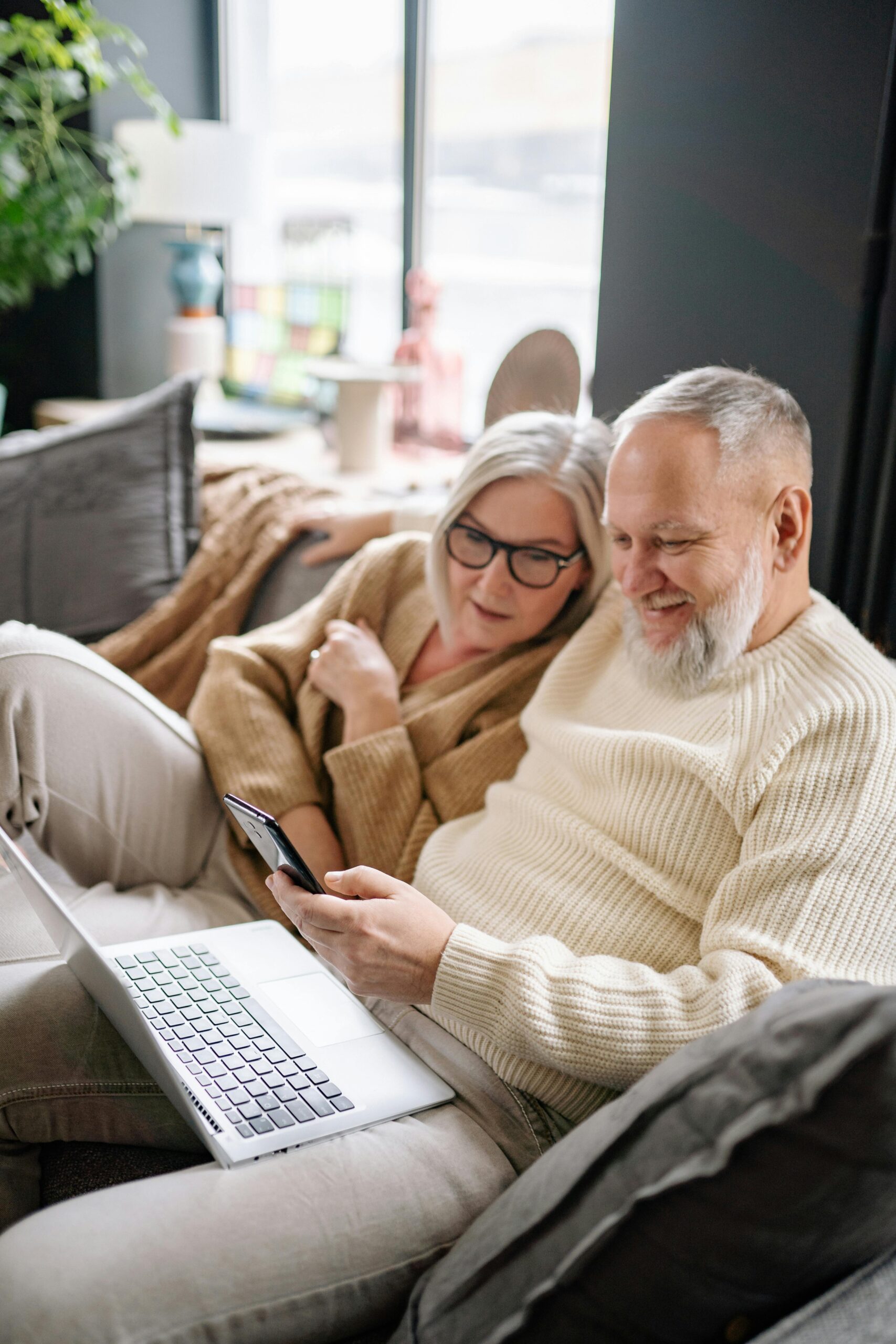 Retired couple doing research on a laptop