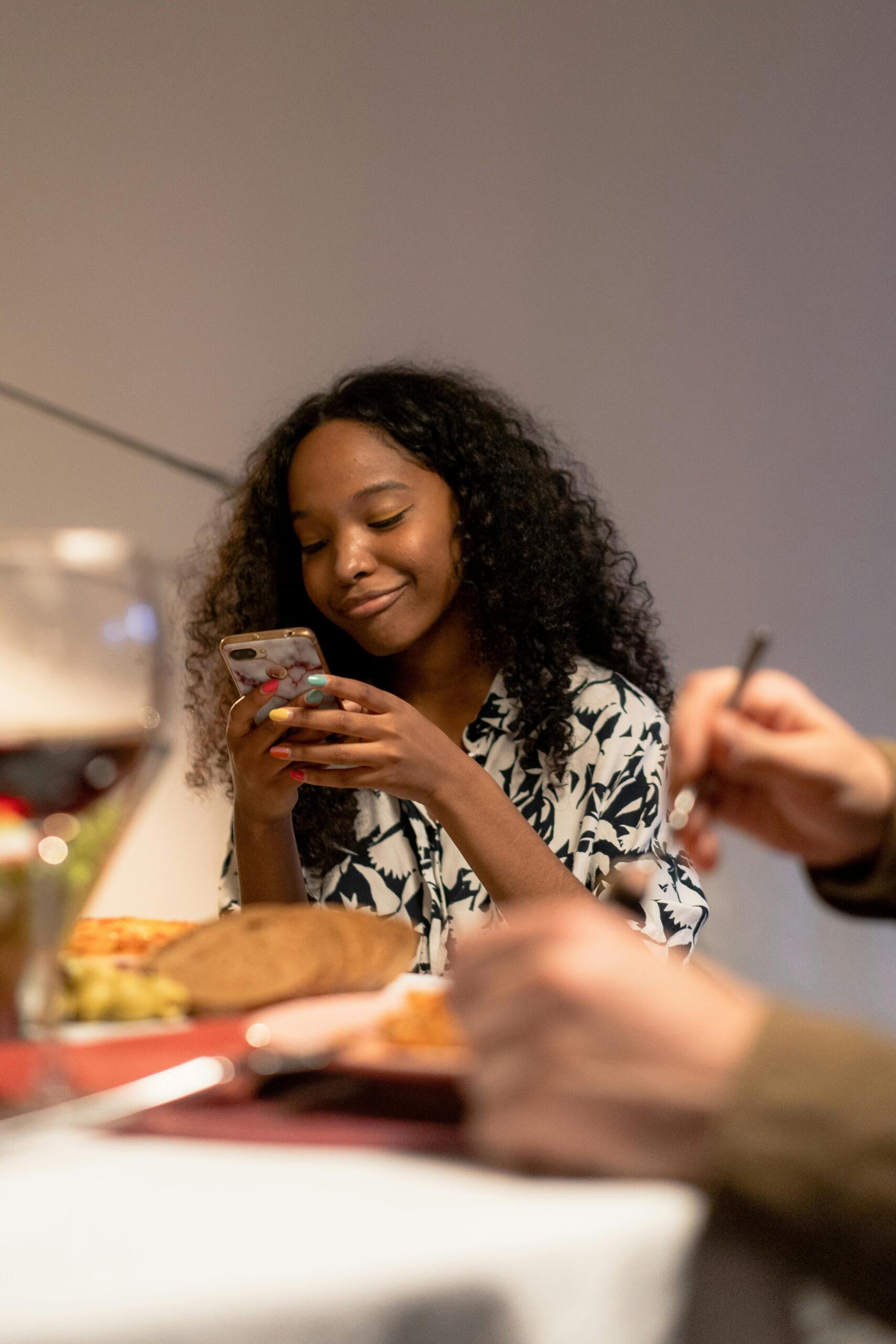 Teenager smiling and using her smartphone