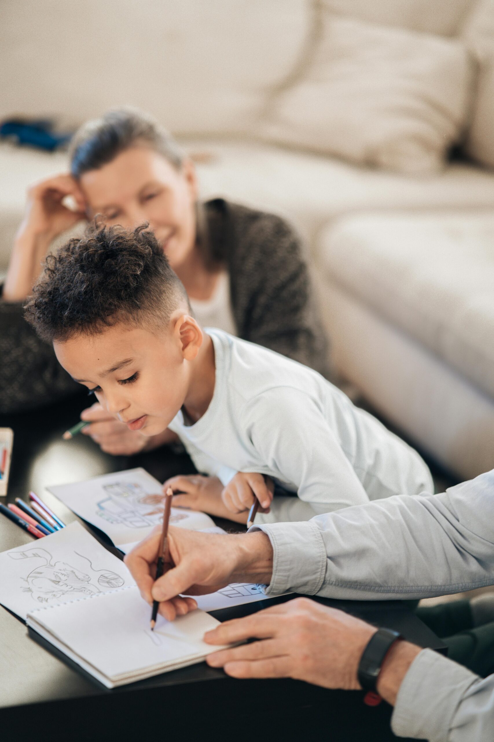 Couple drawing in notebook for child