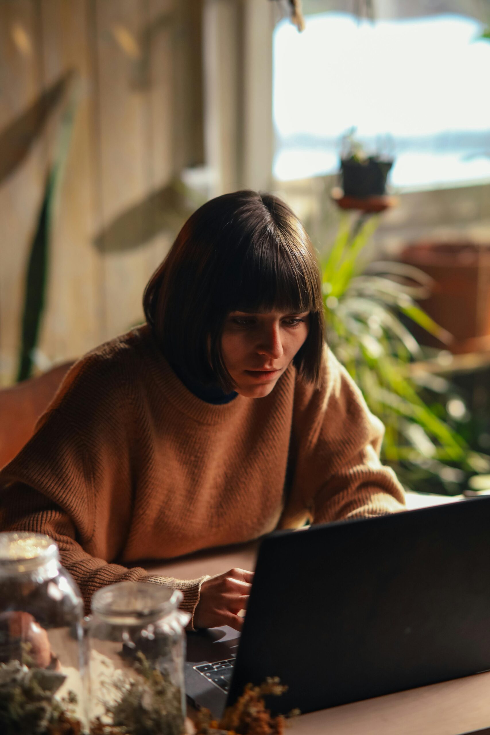 Pensive woman looking at black computer