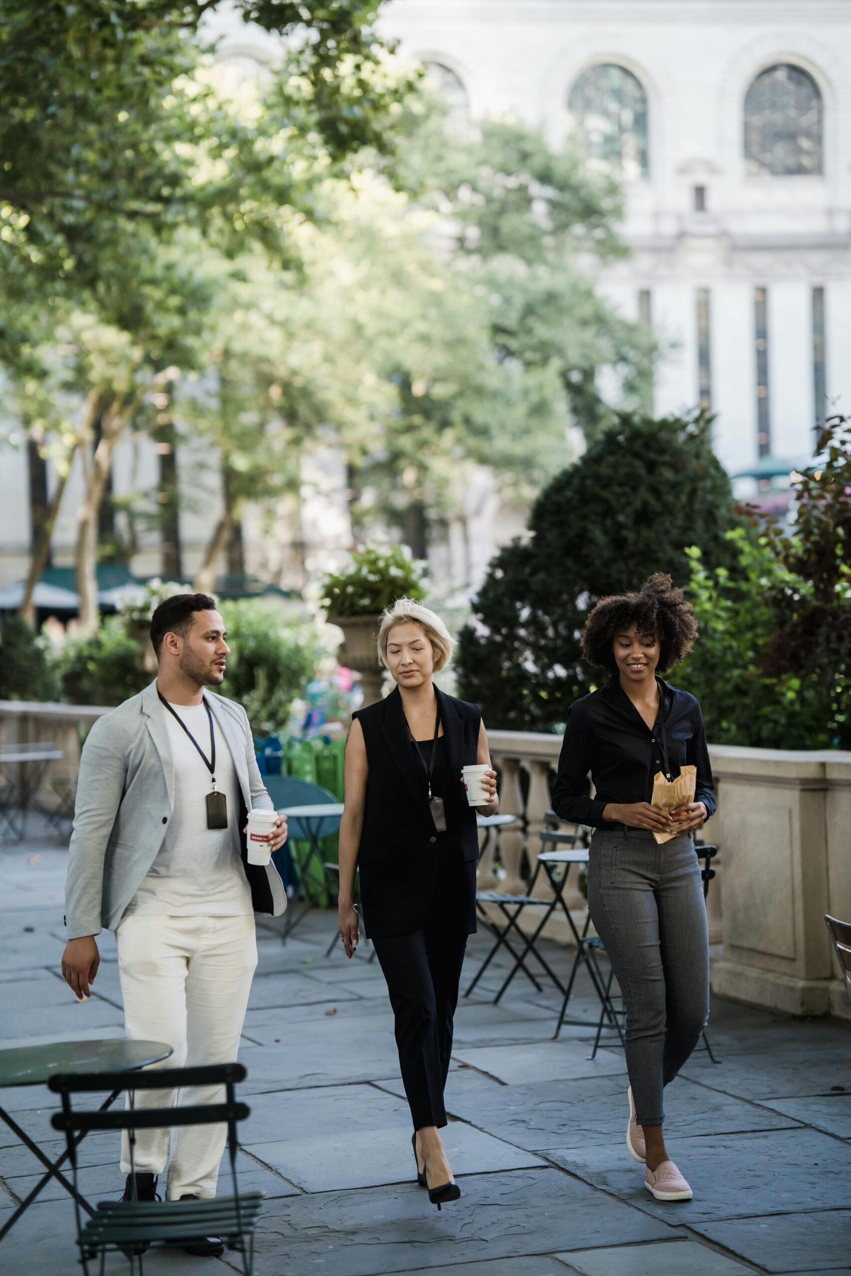 Business people Walking Through Park with Takeout Food