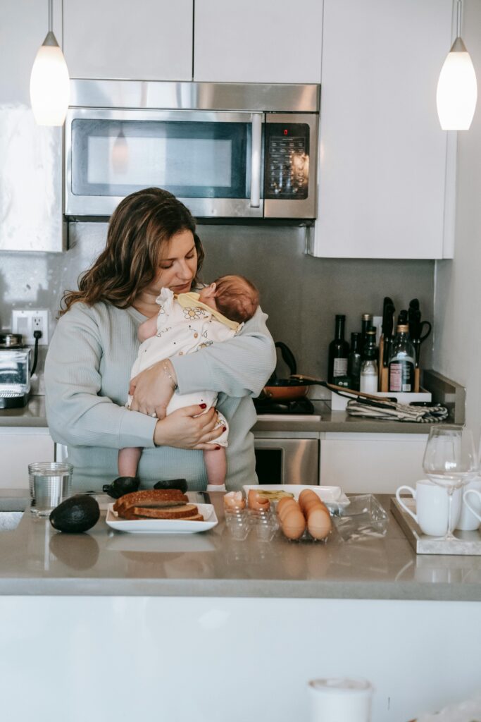 woman soothing infant in kitchen