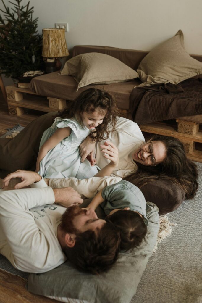 Young family laughing together on the floor