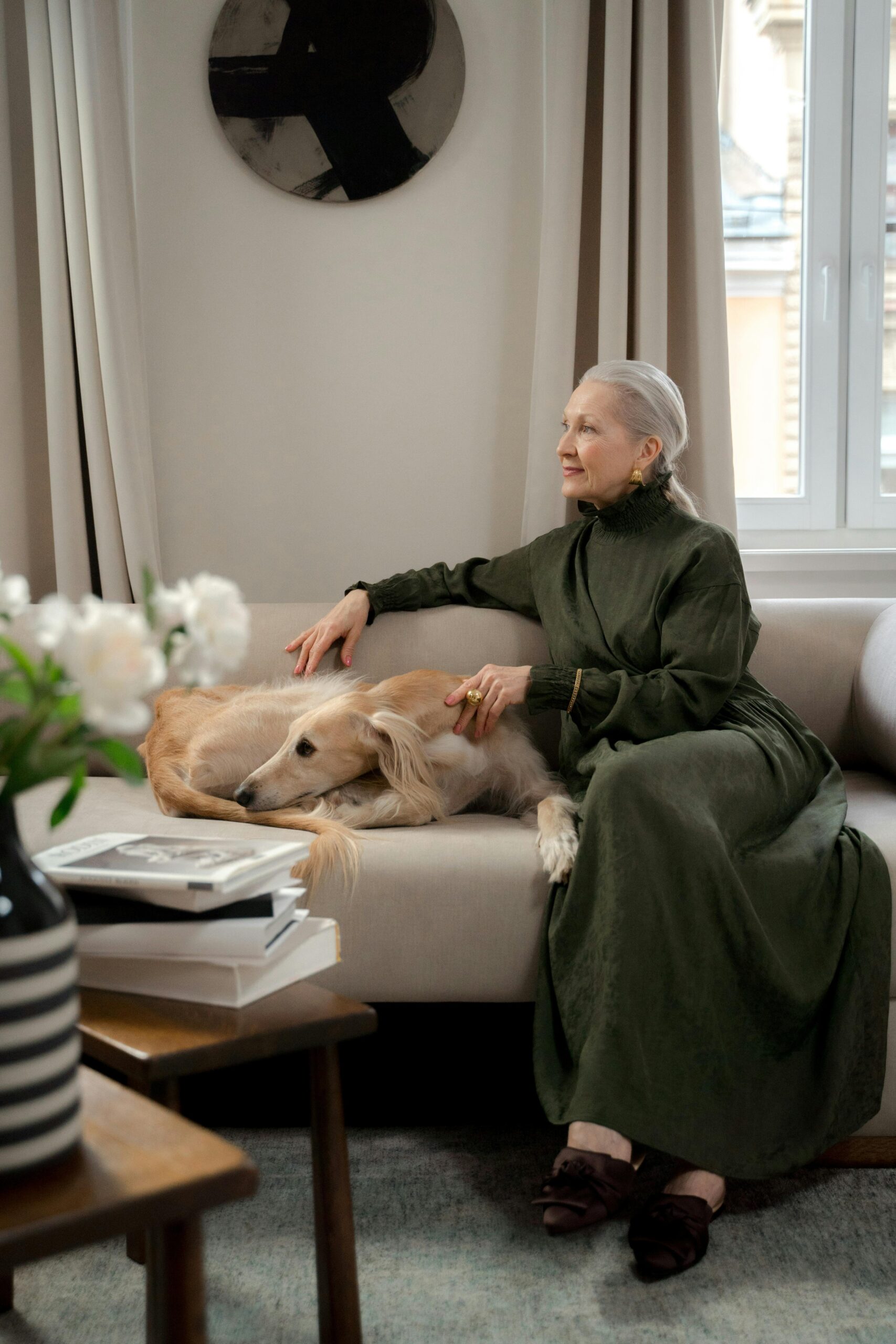 Wealthy woman in formal dining room with dog