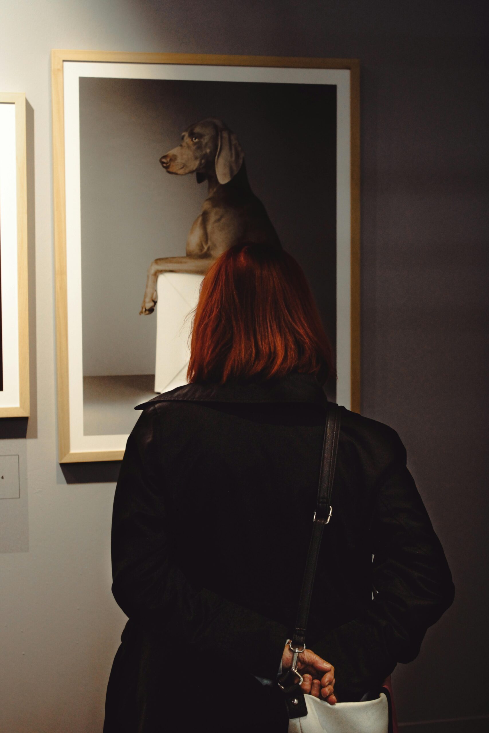 Woman in gallery looking at art and collectibles