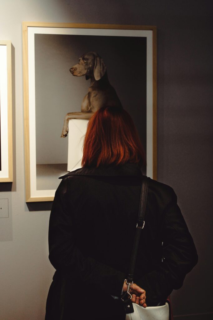 Woman in gallery looking at art and collectibles
