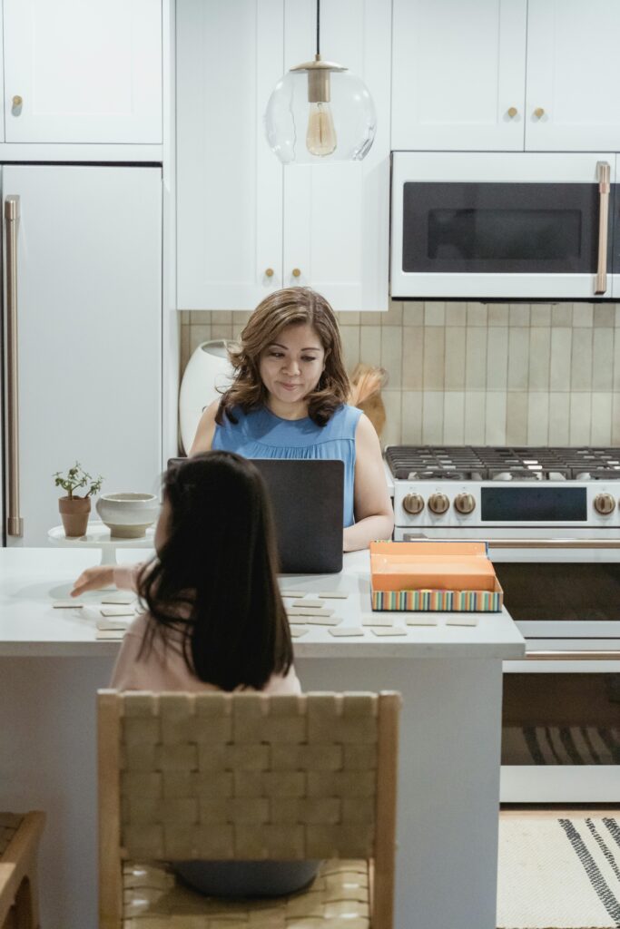 Mother working on computer to manage finances