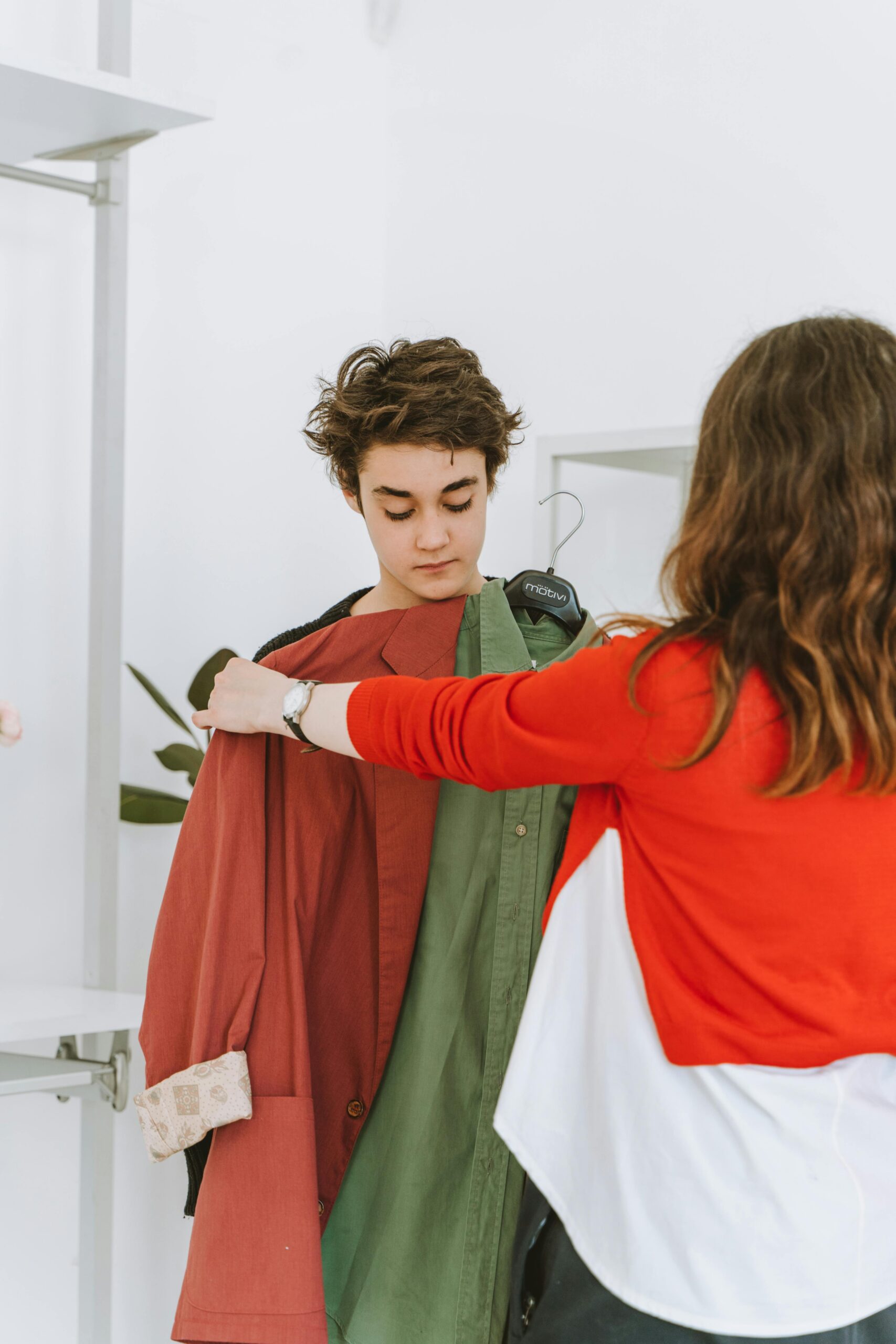 Mother shopping for clothes with son