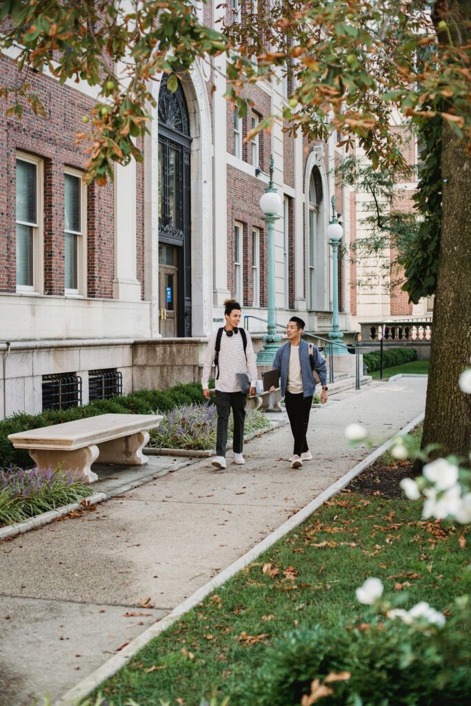 Athletes walking down sidewalk discussing NIL income