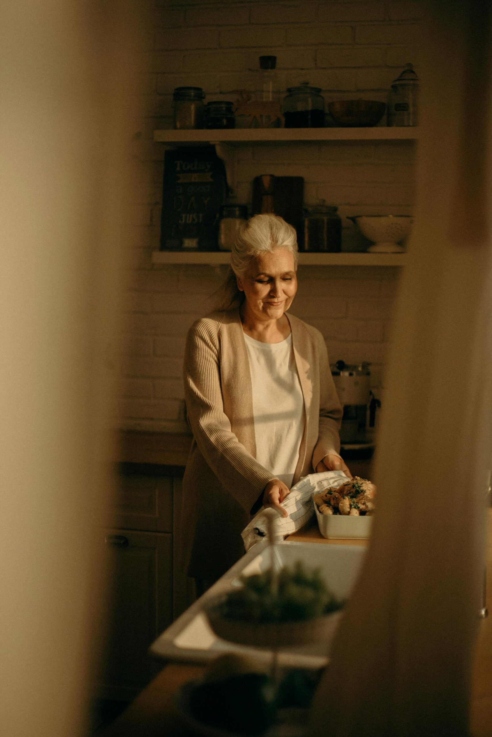 Elderly woman preparing a meal in the kitchen