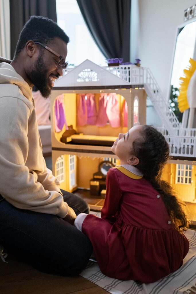 Young girl playing with her father