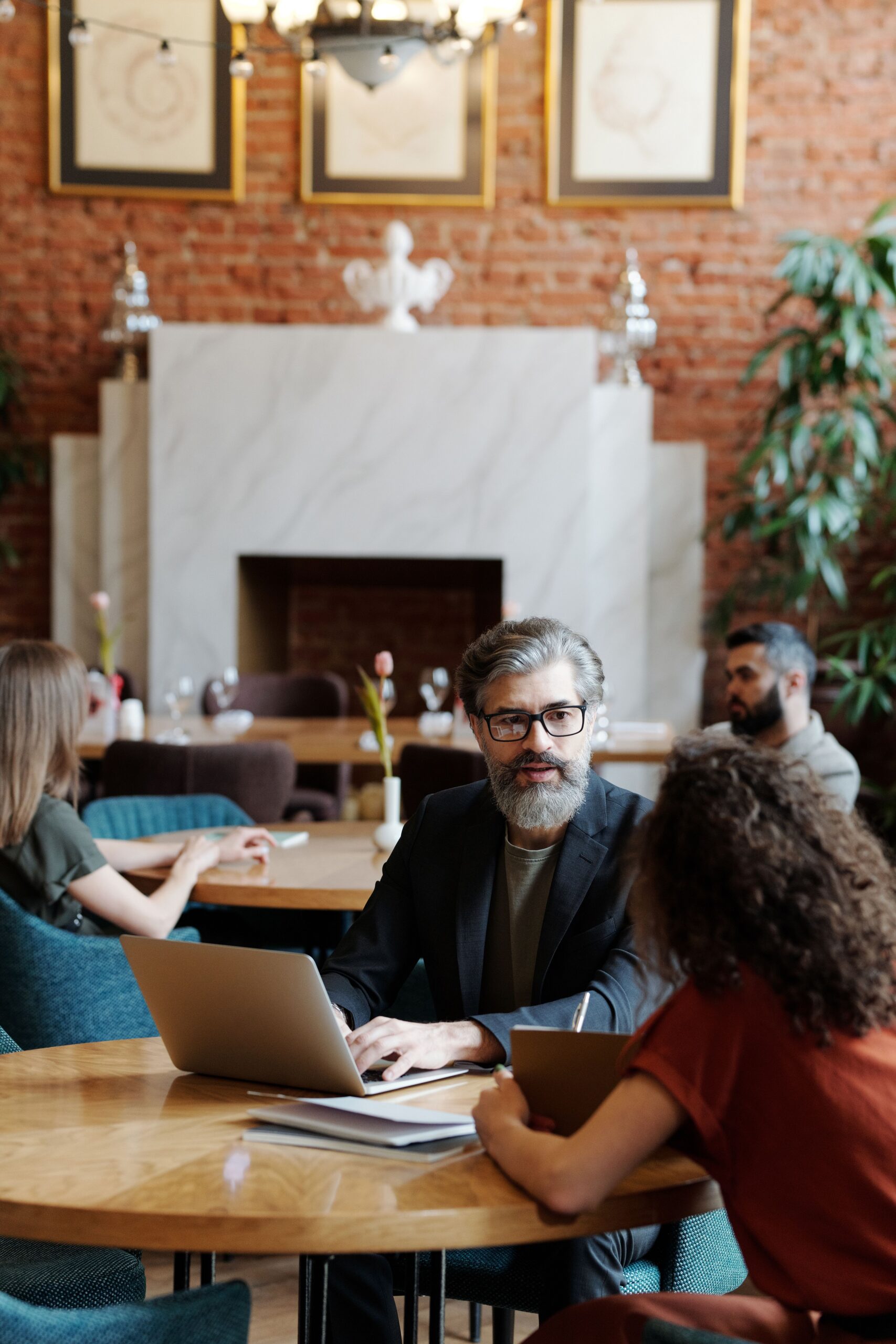 Adults engaged in a collaborative business meeting at a stylish urban café