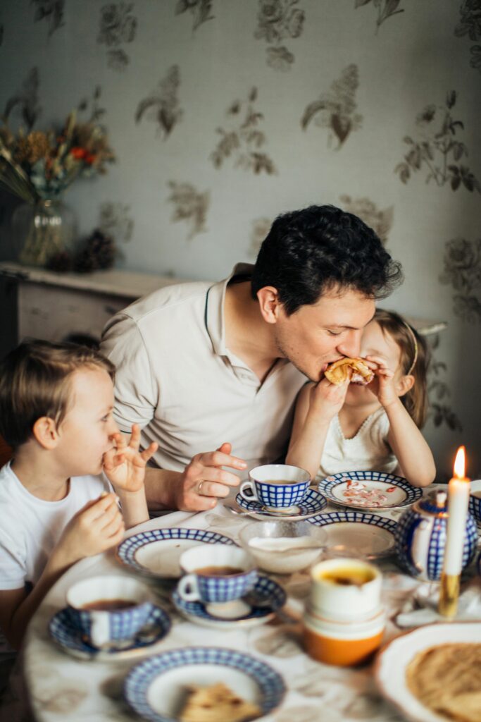 Father eating breakfast with his children