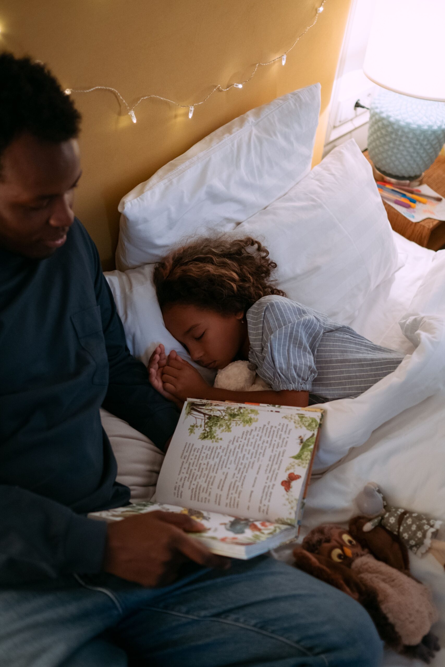 Father reading bedtime story to daughter
